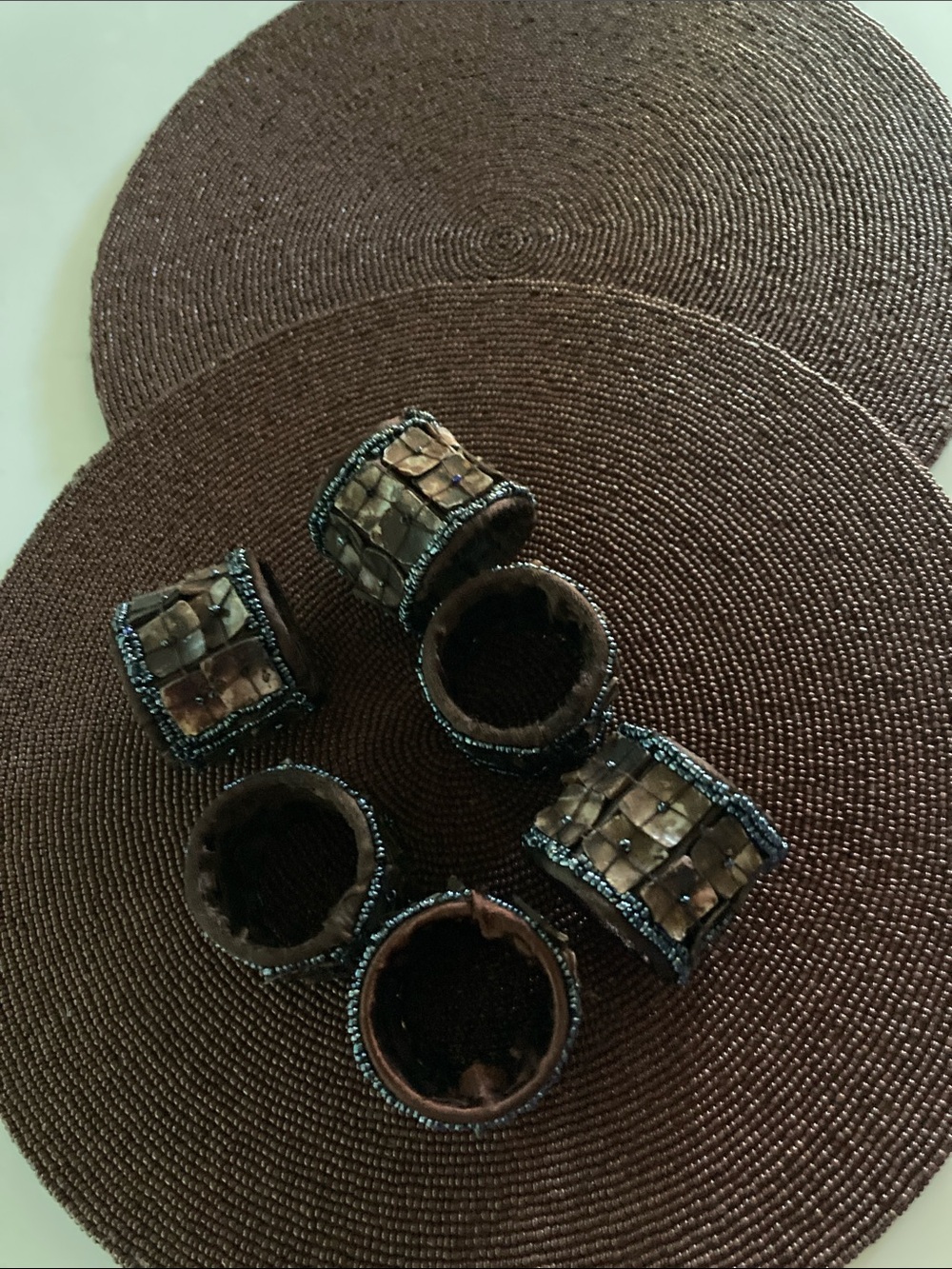 2 plate chargers and 6 napkin rings , glass beads, brown